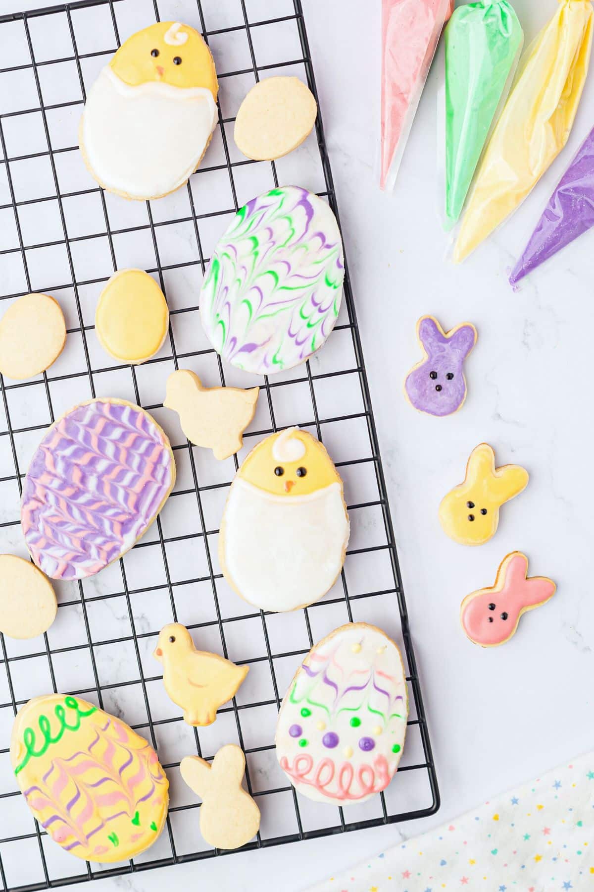 Iced cookies on a wire rack drying.