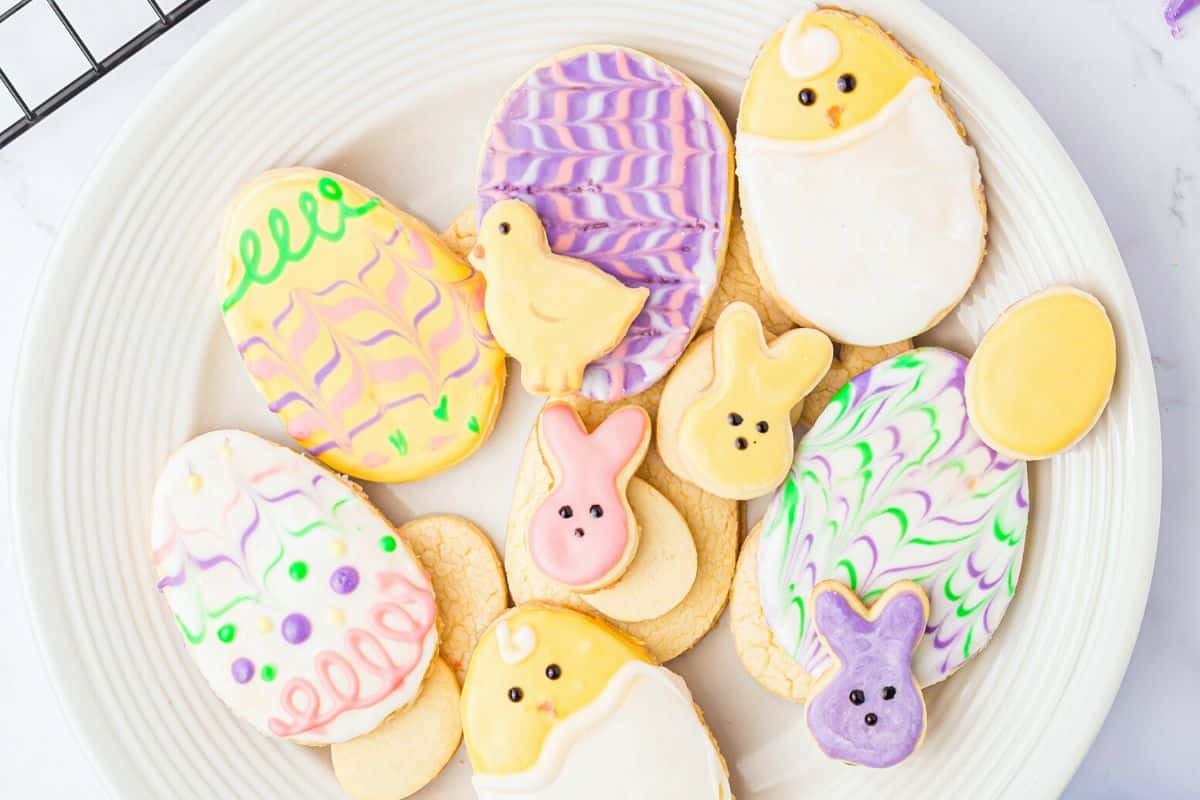 A close up view of a plate of Easter shaped cookies.