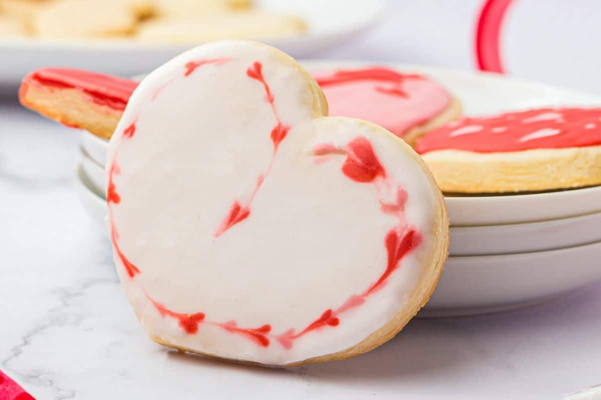 A heart shaped cookie with fancy heart edging.