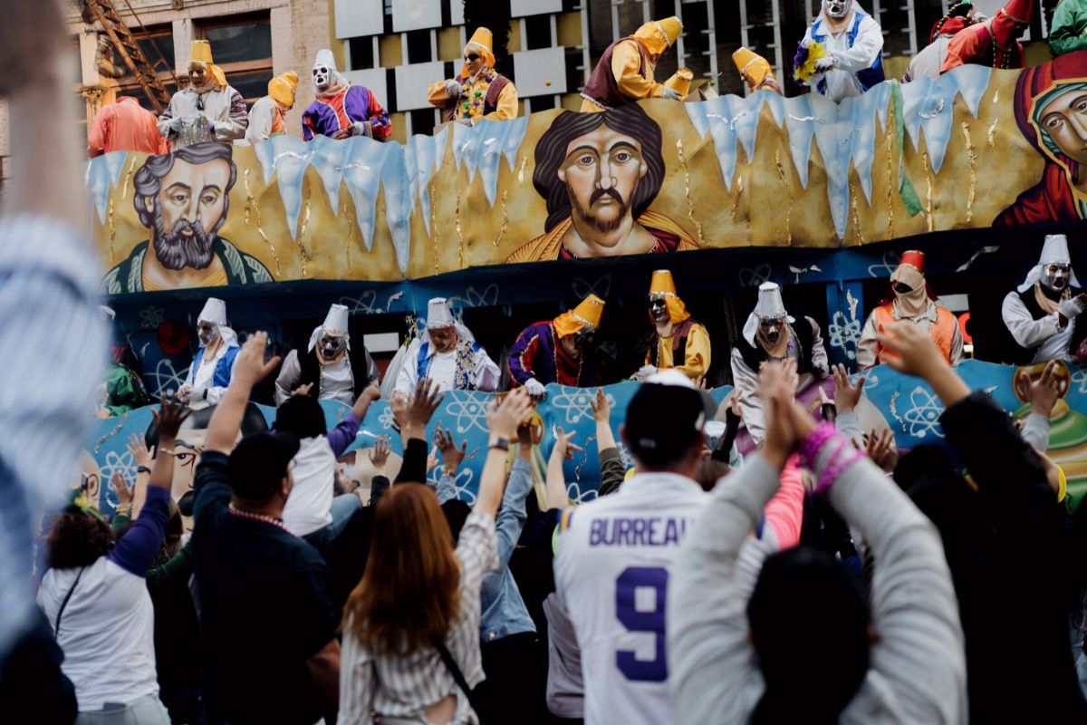 A photo of people partying on Bourbon Street at Mardi Gras.