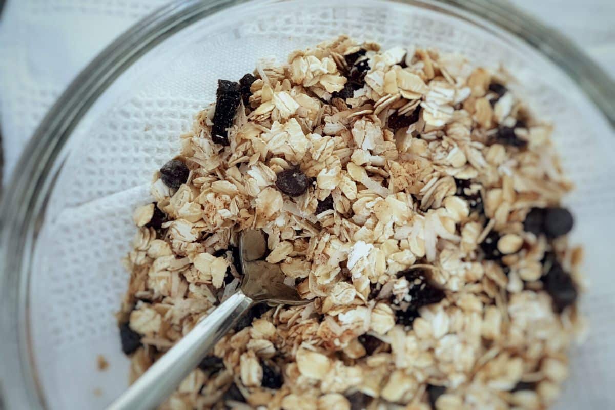 Gluten free oats and other ingredients in a glass mixing bowl.