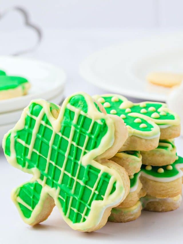 A stack of decorated gluten free shamrock cookies for St. Patrick's Day.
