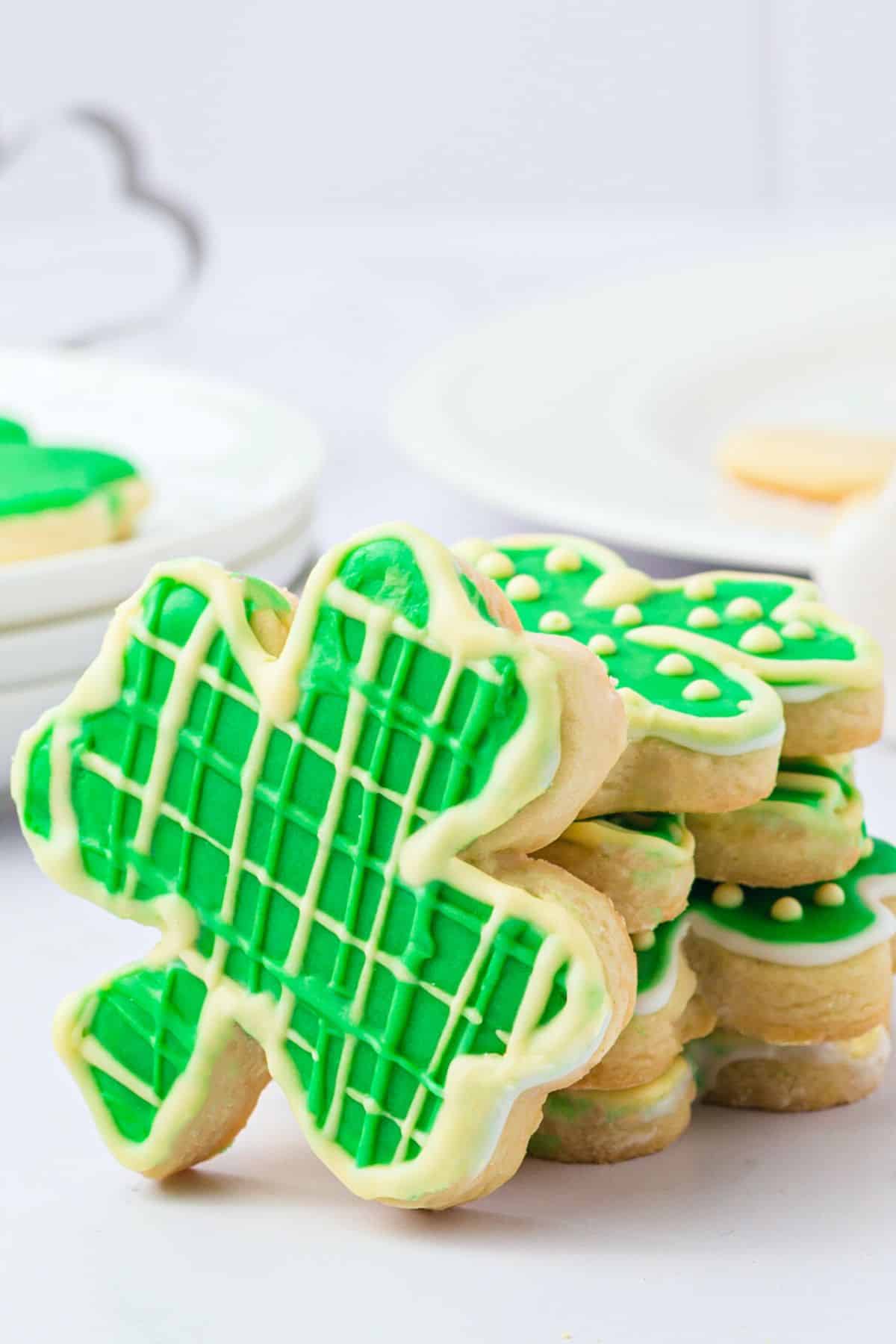 A stack of decorated gluten free shamrock cookies for St. Patrick's Day.