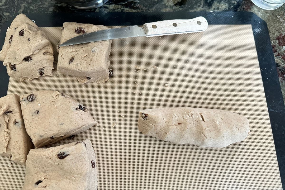 Rolling the dough into bagels shapes.