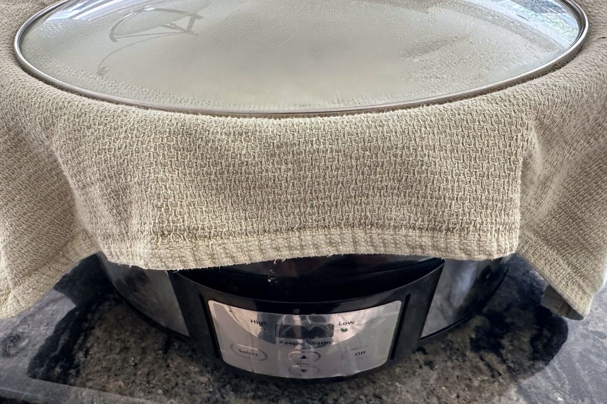 A kitchen towel over the slow cooker, but under the lid to catch condensation.