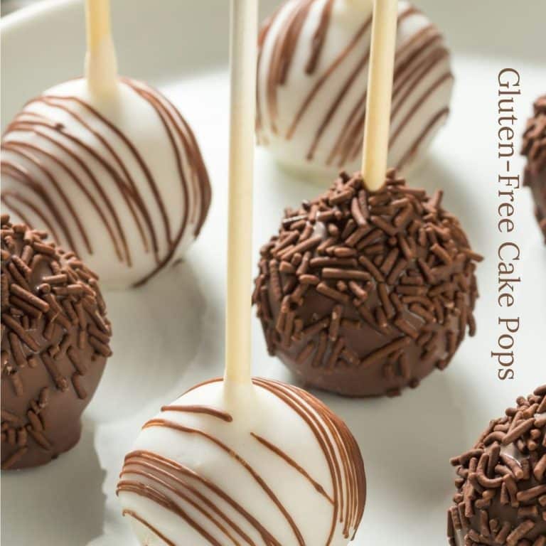 Vanilla and chocolate decorated cake pops on a white plate.