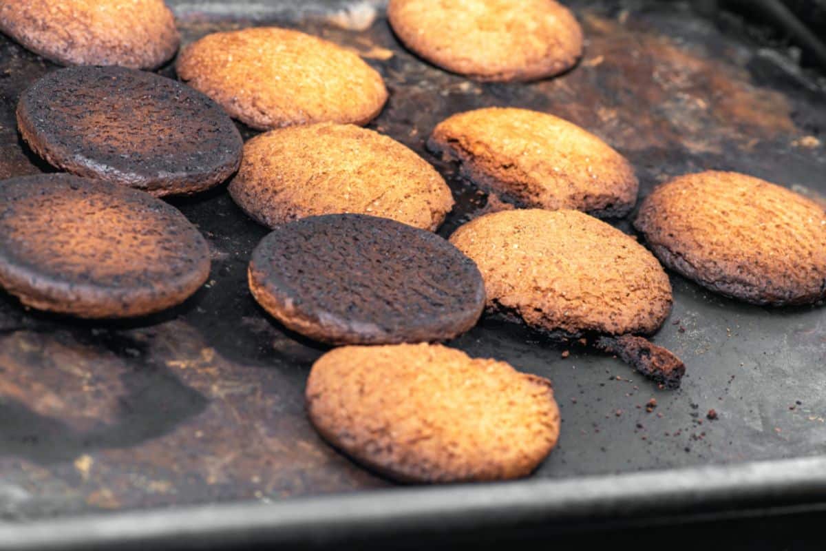 Burnt cookies on a cookie sheet.