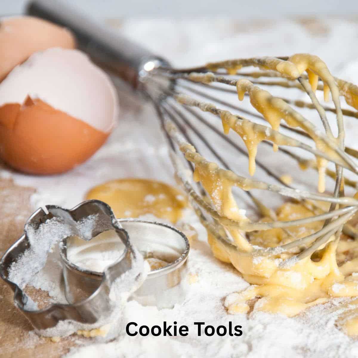 Some of my favorite cookie making tools like a whisk and cookie cutters.