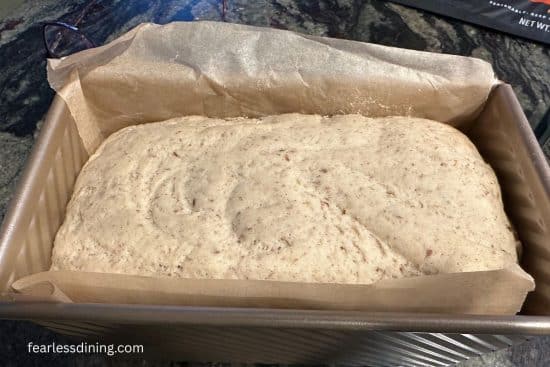 Gluten-free bread dough in a pullman loaf pan.