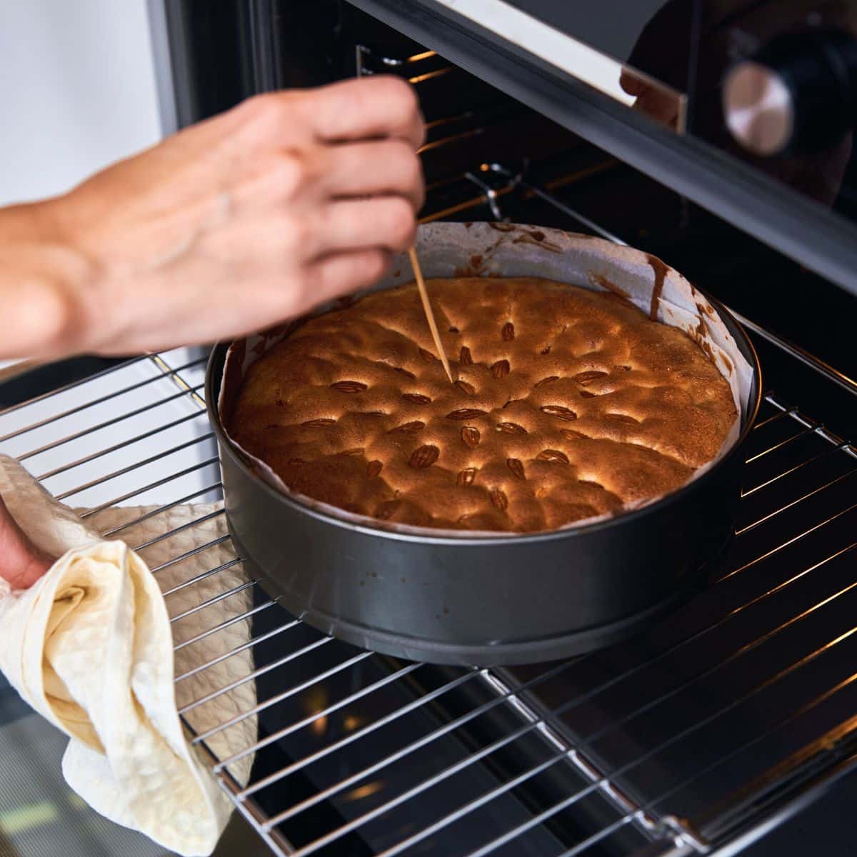 Poking a toothpick into a baked cake to see if it is done baking.