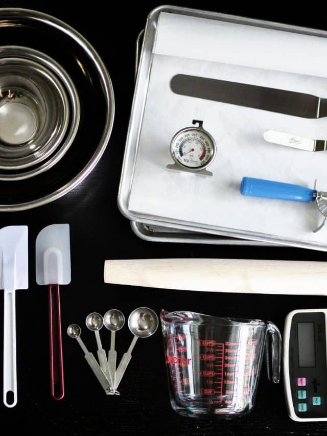 Some kitchen baking tools on a black granite counter.