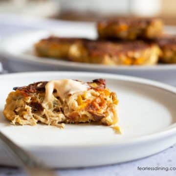 A lion's mane crab cake on a plate. It is cut in half so you can see the inside.