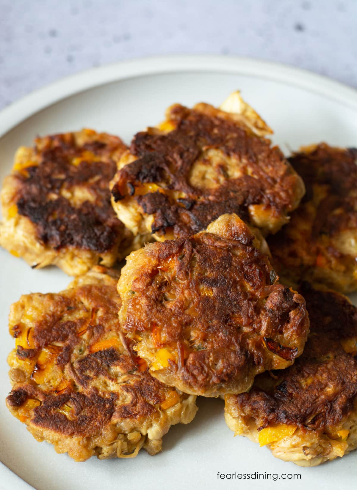 A platter full of pan fried lion's mane crab cakes.