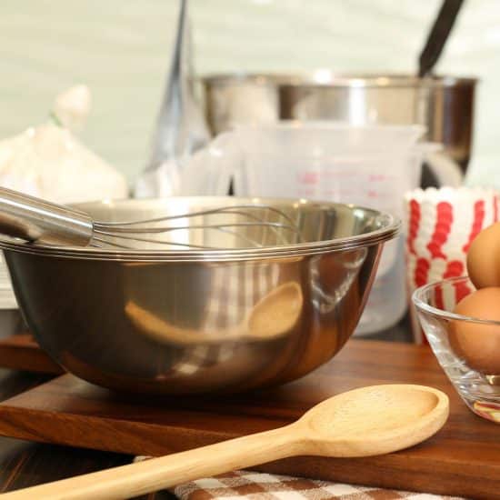 Mixing bowls and other cake making equipment on a kitchen counter.