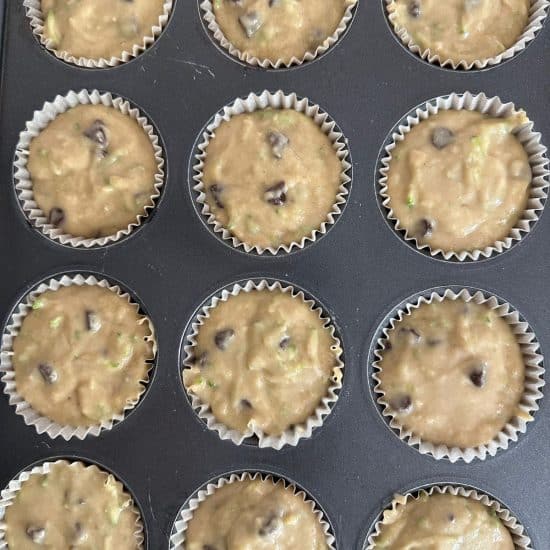 Muffin batter in a muffin pan, ready to bake.