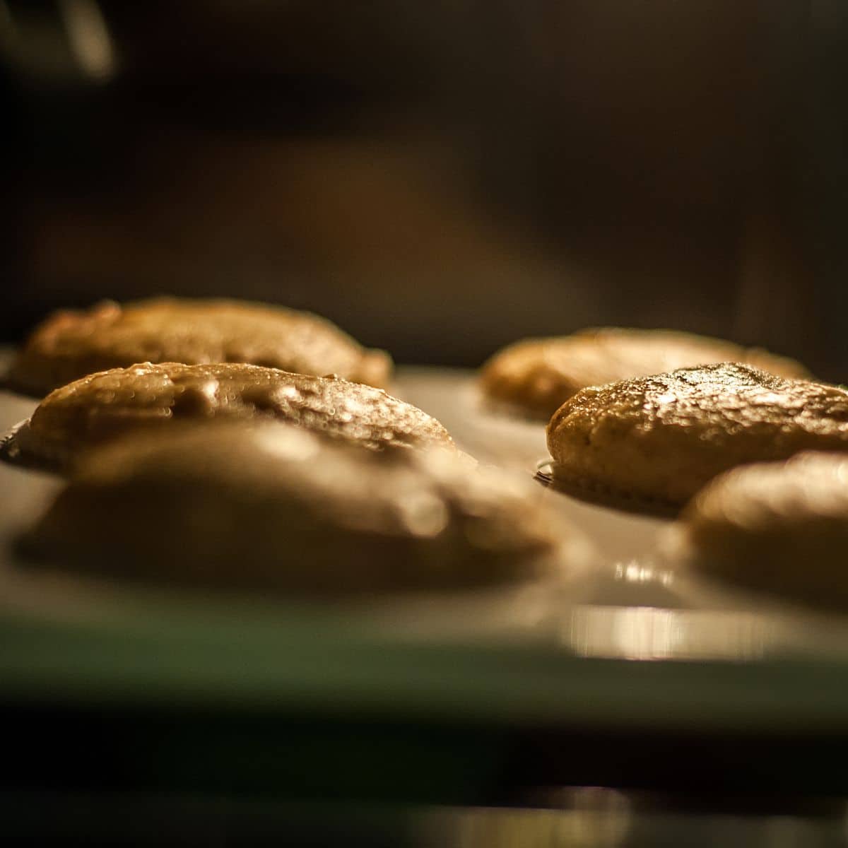 A picture of muffins baking in the oven.