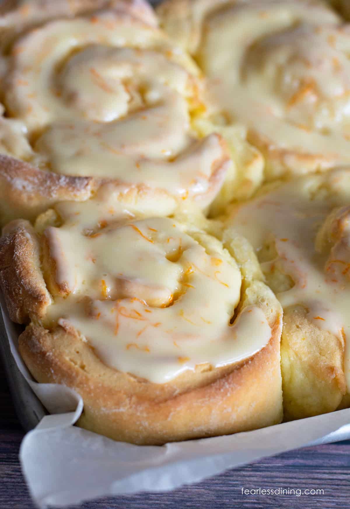 Check out these big fluffy gluten free orange rolls rolled up with an orange icing.