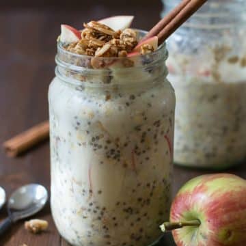 Gluten free overnight oats in two mason jars. The oats are topped with apple granola.