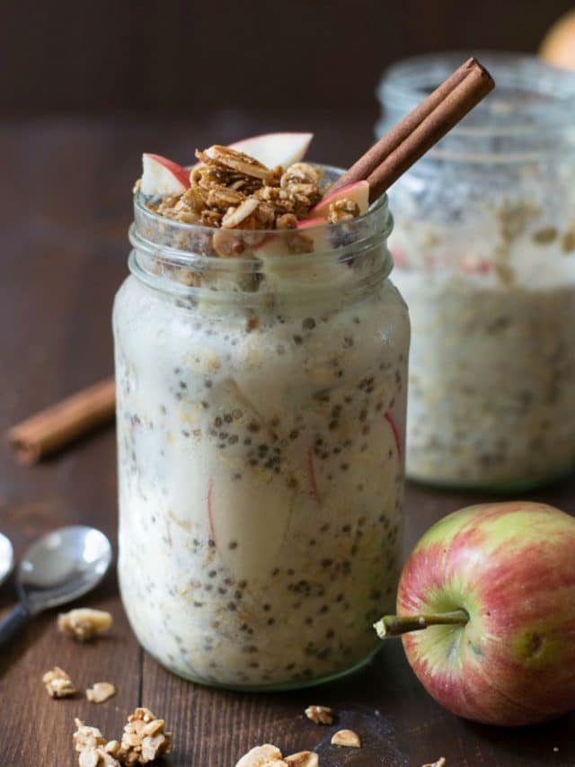Gluten free overnight oats in two mason jars. The oats are topped with apple granola.