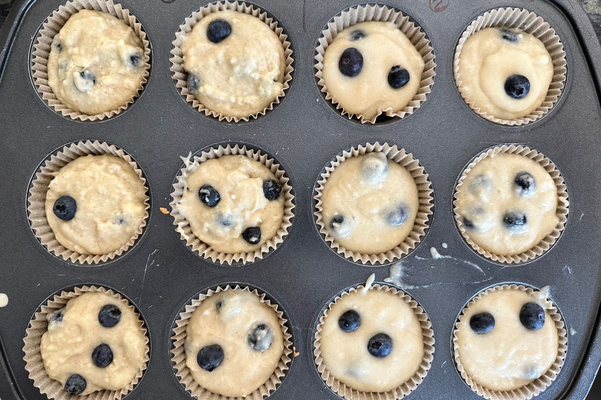 Two test batter muffins in a muffin pan.