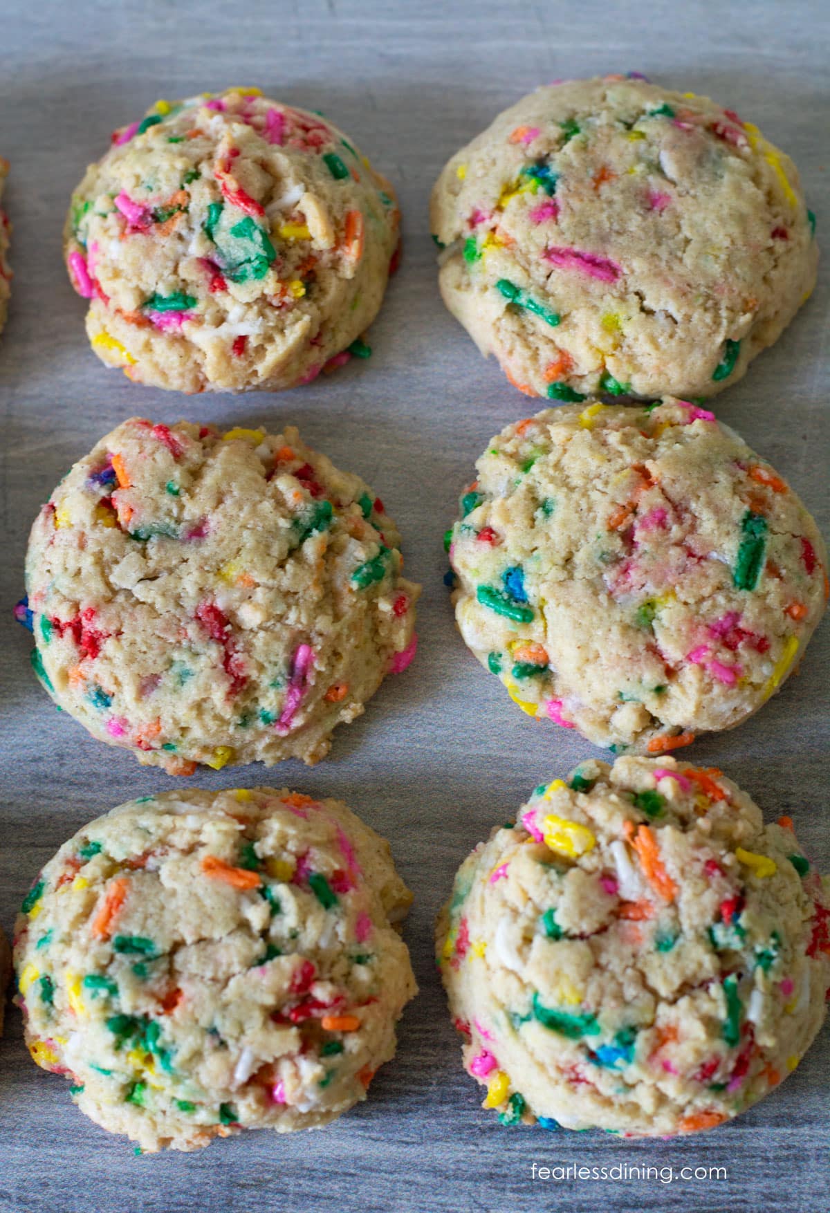 Baked gluten-free funfetti cookies on a cookie sheet.