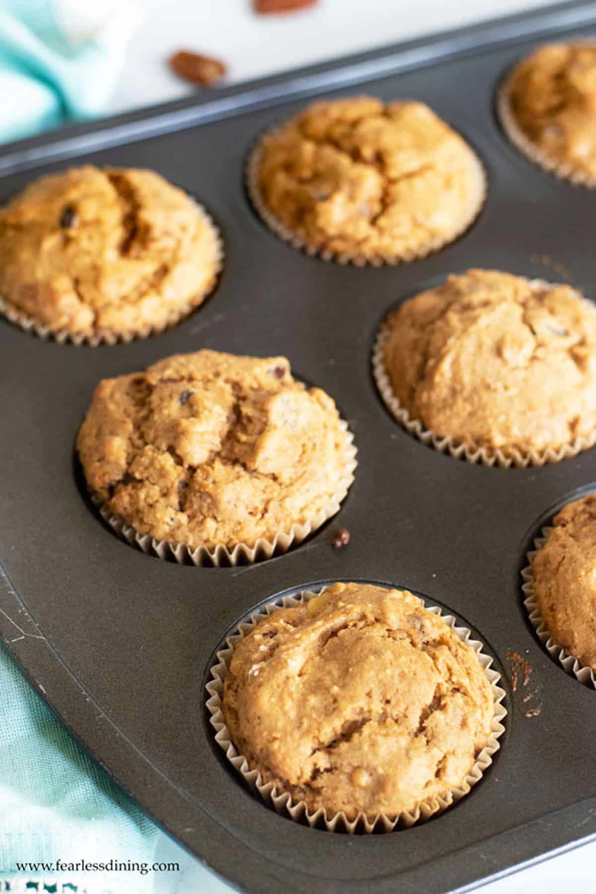 A rack full of baked gluten free banana muffins.