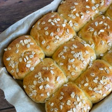 A pan filled with baked honey rolls.