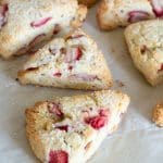 Baked gluten free strawberries and cream scones on a baking sheet.