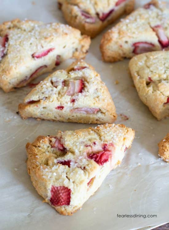 Baked gluten free strawberries and cream scones on a baking sheet.