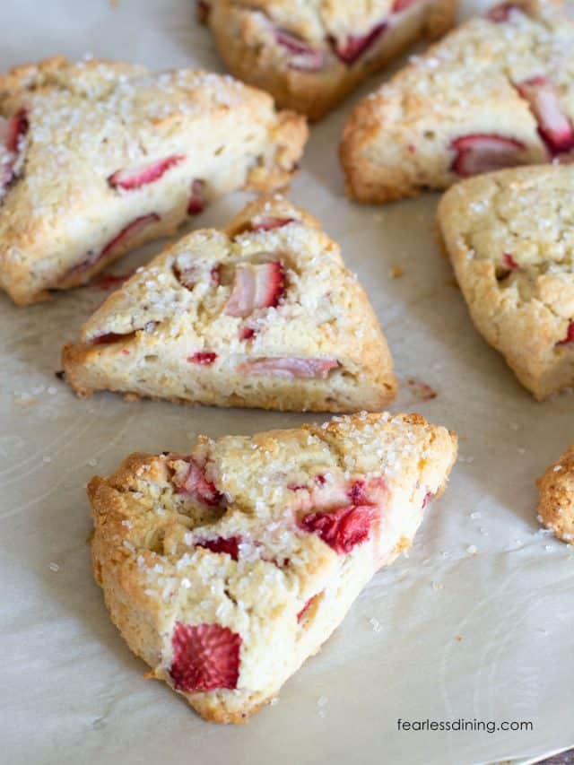 Baked gluten free strawberries and cream scones on a baking sheet.