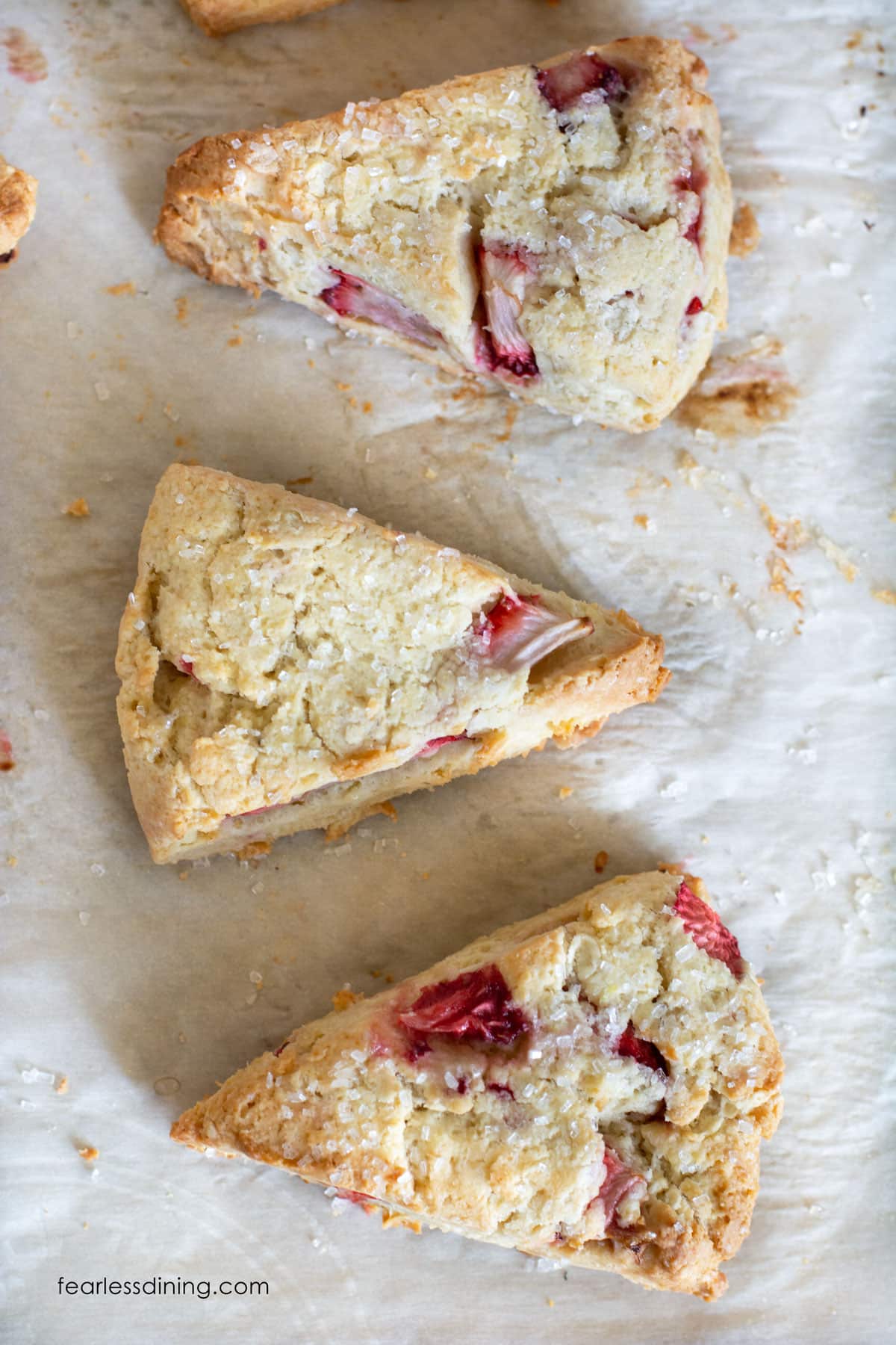 The top view of gluten free strawberry scones on a baking sheet.