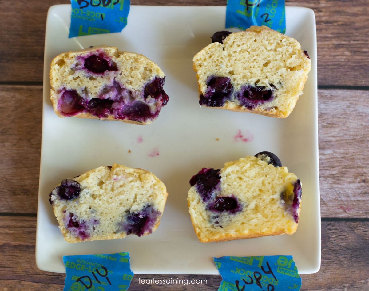 A square plate with half of each muffin tested so you can see the insides of the muffins.