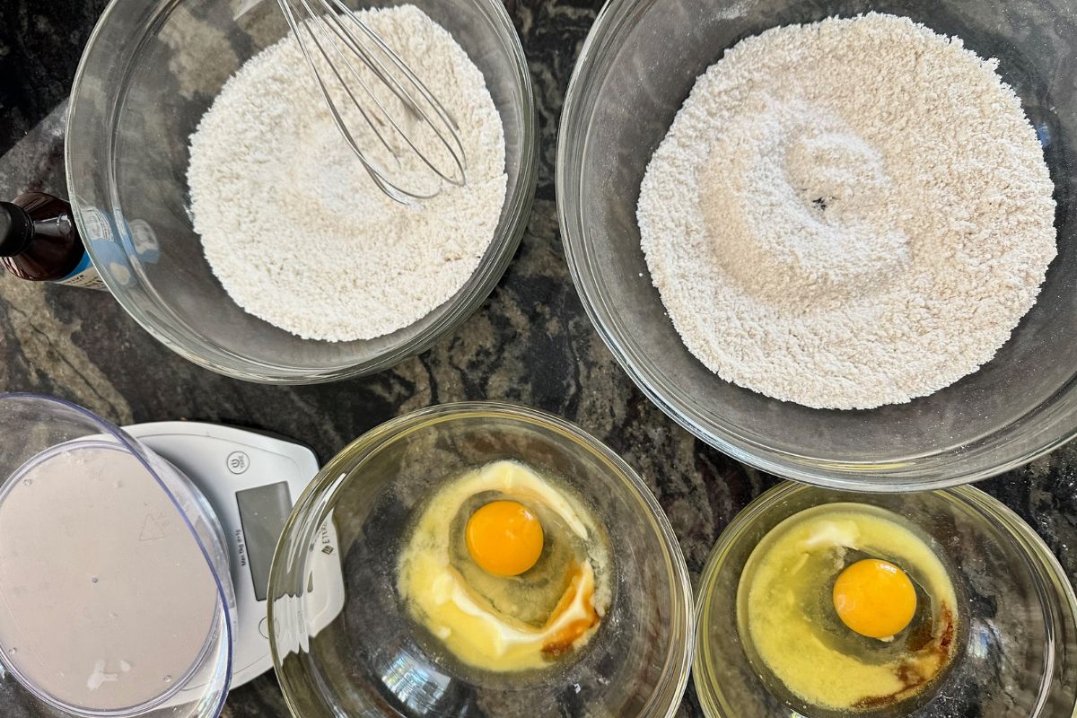 Bowls filled with different flour blends and wet ingredients.