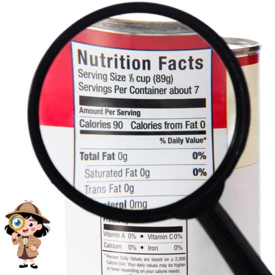 A magnifying glass emphasizing a nutrition label on a can of food.