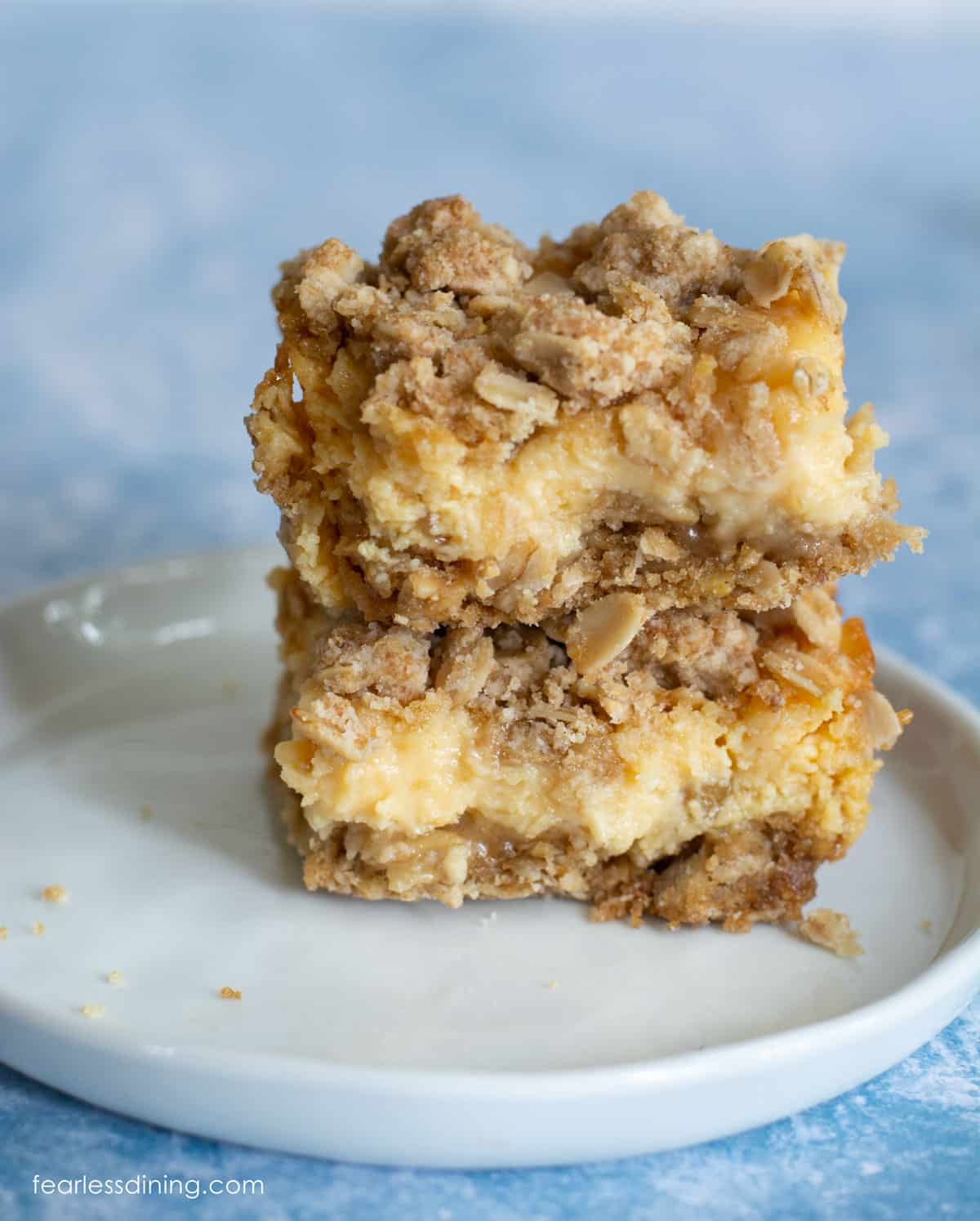 Two gluten free lemon oat bars stacked on top of each other.