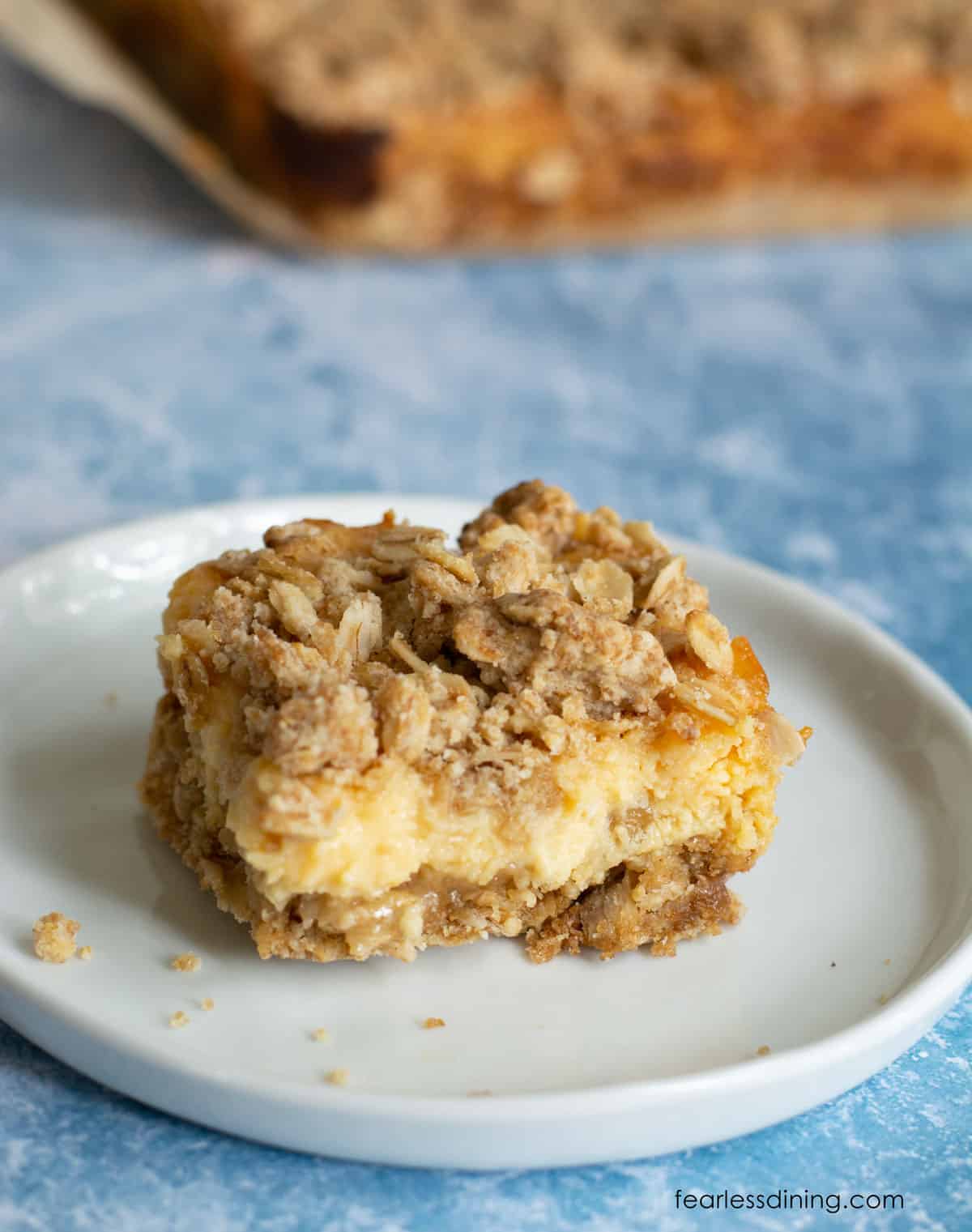 A gluten free lemon oat bar on a small white plate.