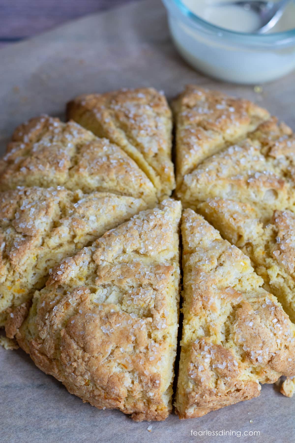 Scones ready to be iced on a baking sheet.