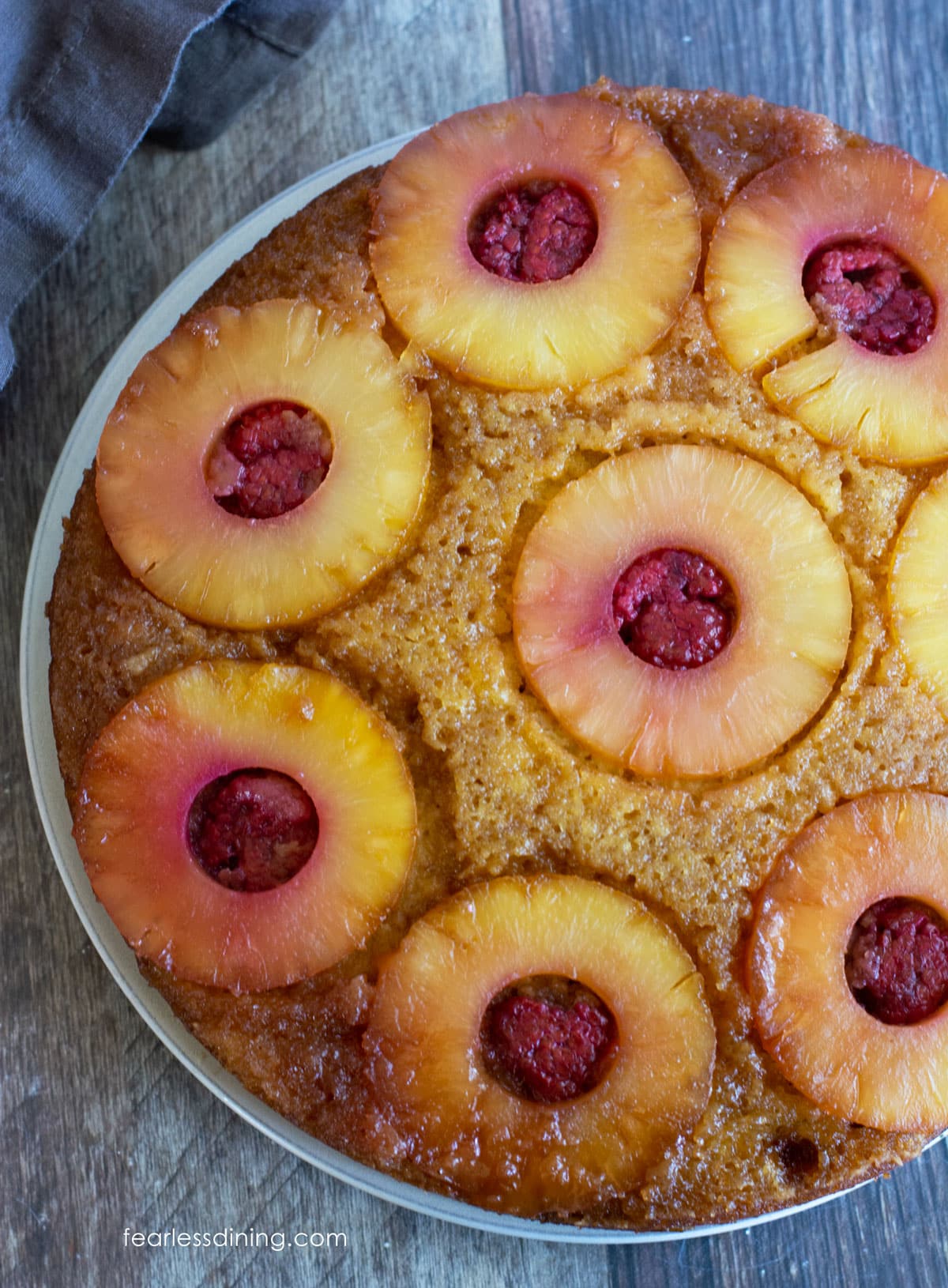 The top view of the baked cake on a large white plate.