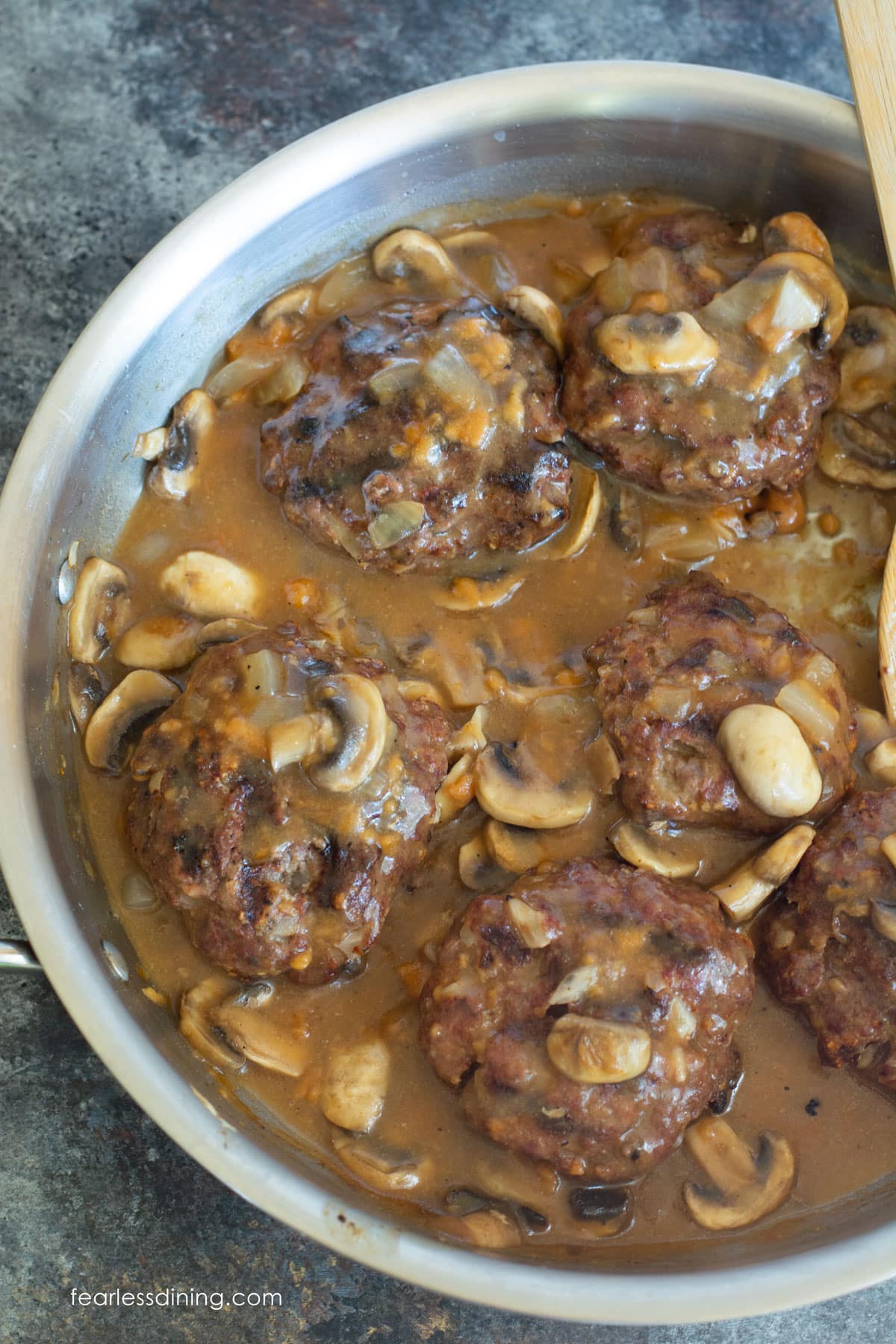 A pan full of cooked Salisbury Steak.