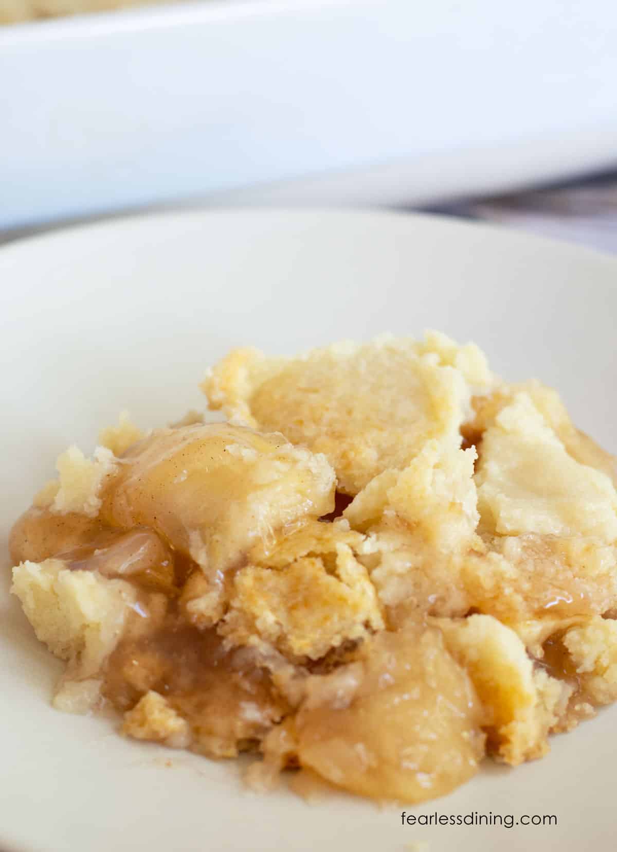 A picture of a serving of apple dump cake on a plate.
