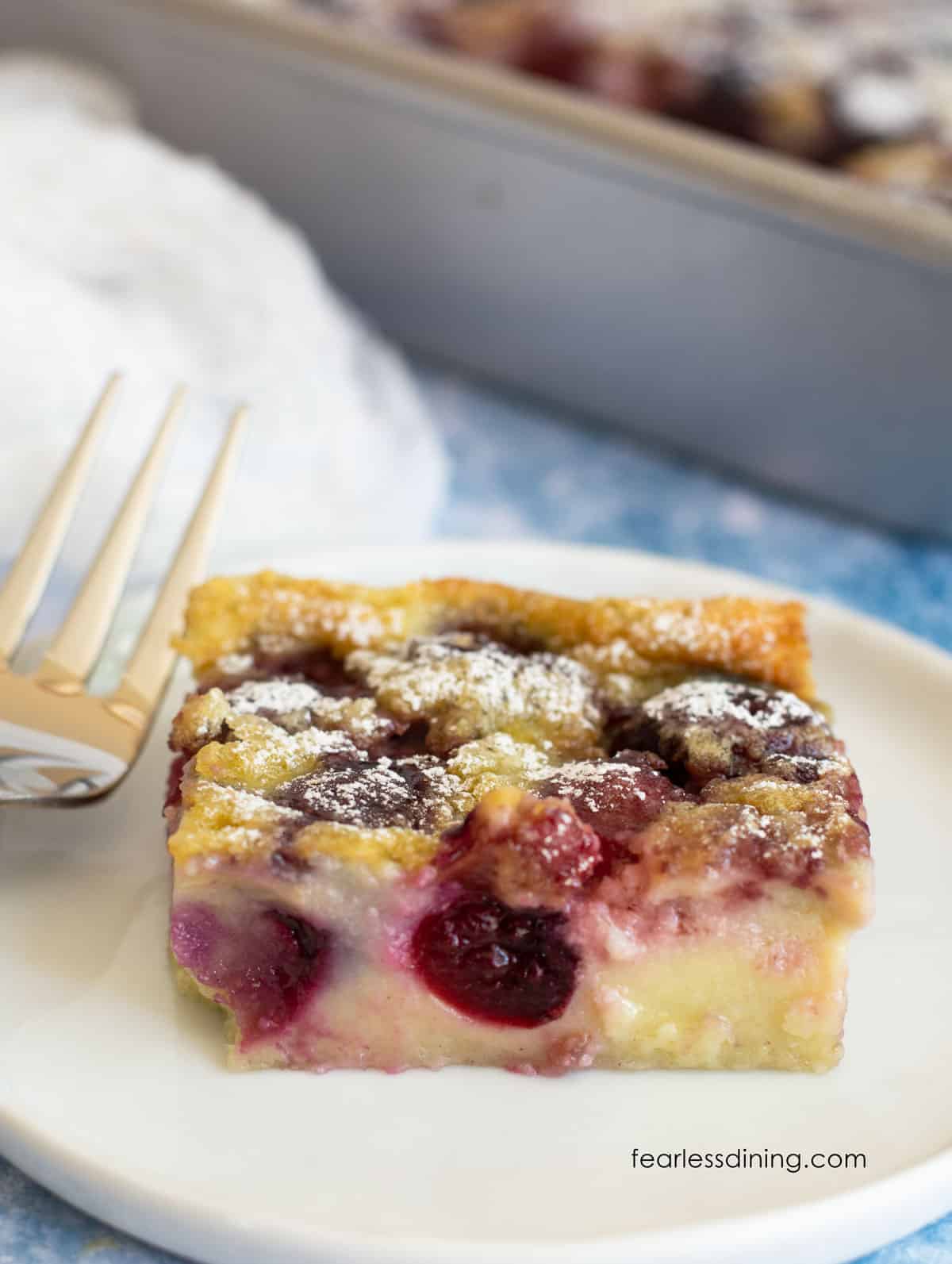 A slice of cherry clafoutis cake on a plate.