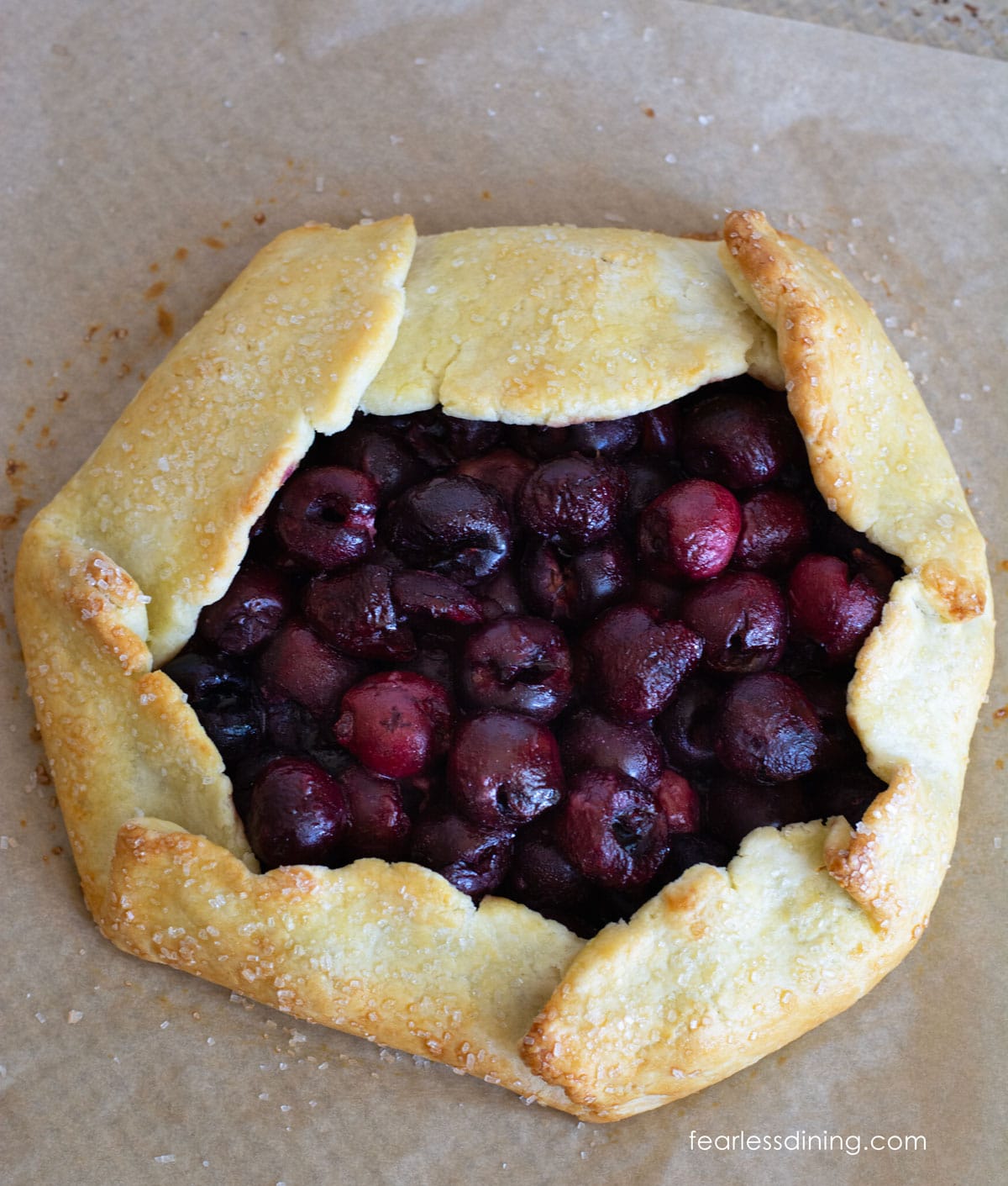 A baked gluten free cherry galette on a baking tray.