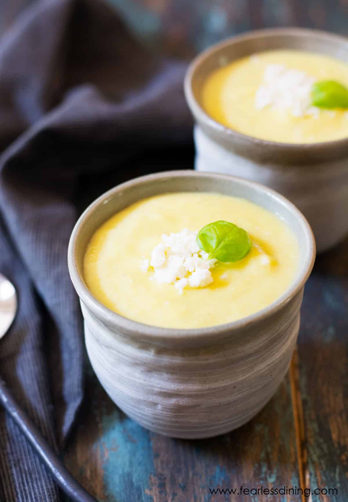 Two small bowls of chilled pineapple soup.