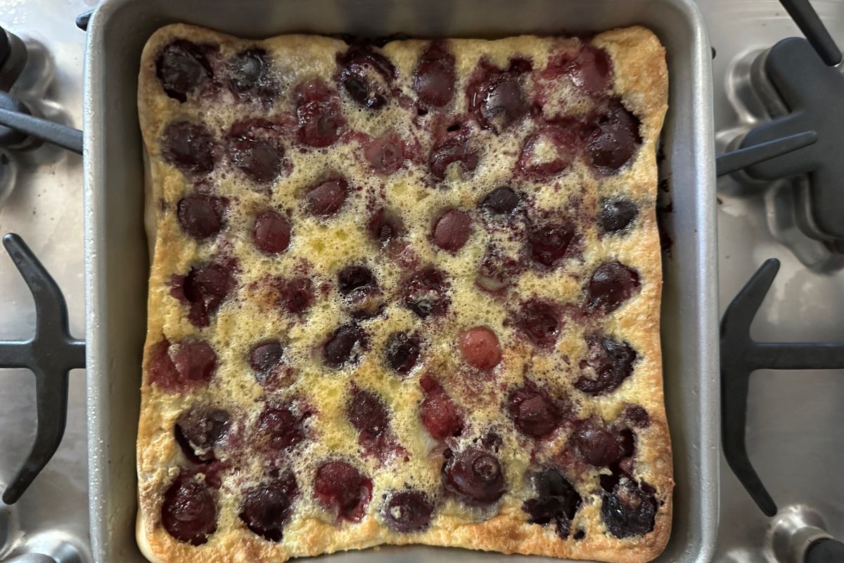 The baked cherry clafoutis in the pan.
