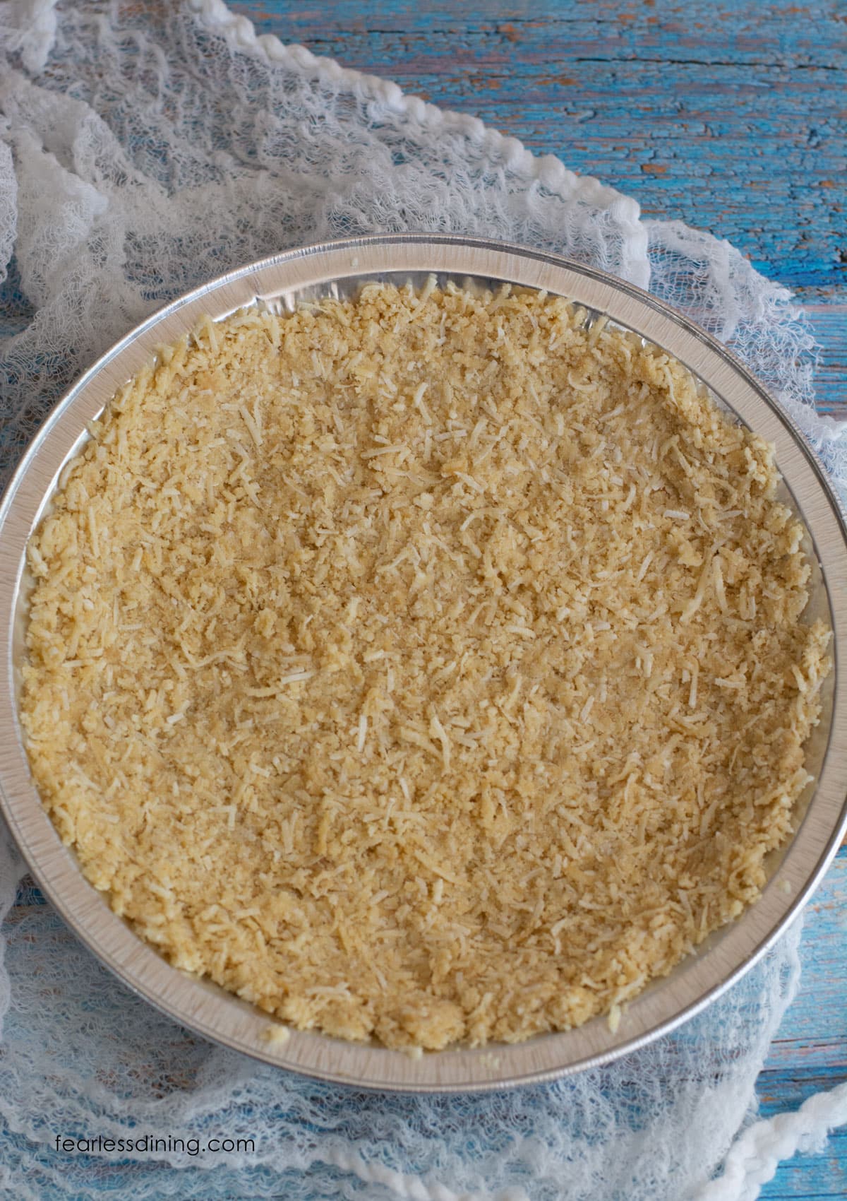 A coconut almond pie crust on a table.