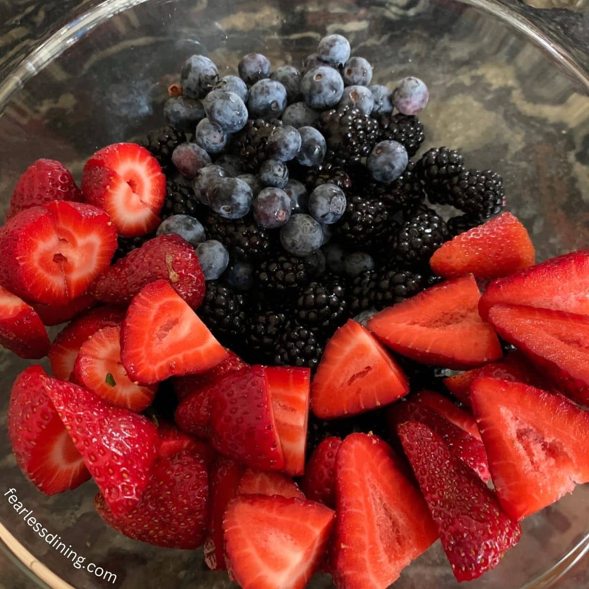 Fresh strawberries, blueberries, raspberries, and blackberries in a bowl.