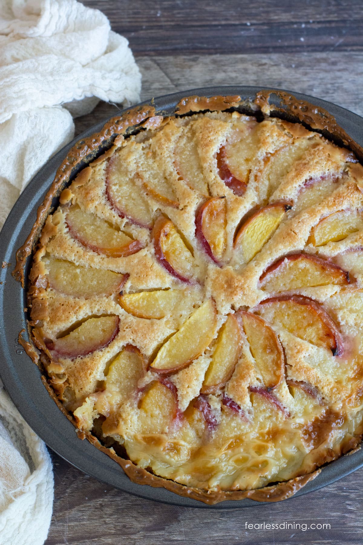 A baked gluten free peach kuchen in the pan.