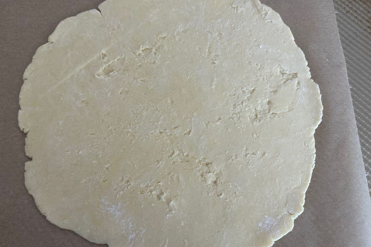 Rolled galette dough on a baking sheet.