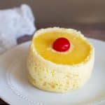 A gluten free pineapple upside down mug cake on a white plate.