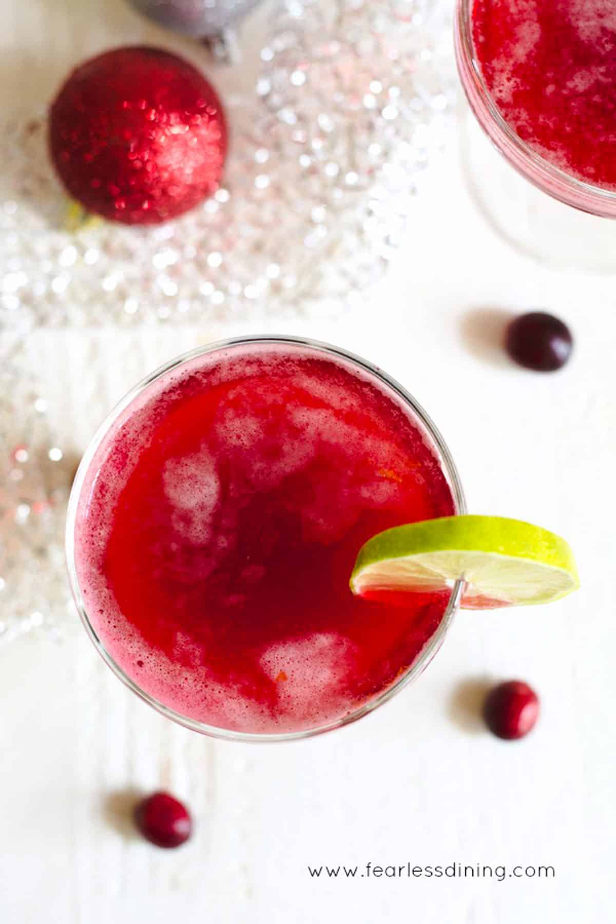 The top view of two glasses of cranberry rum cocktail.